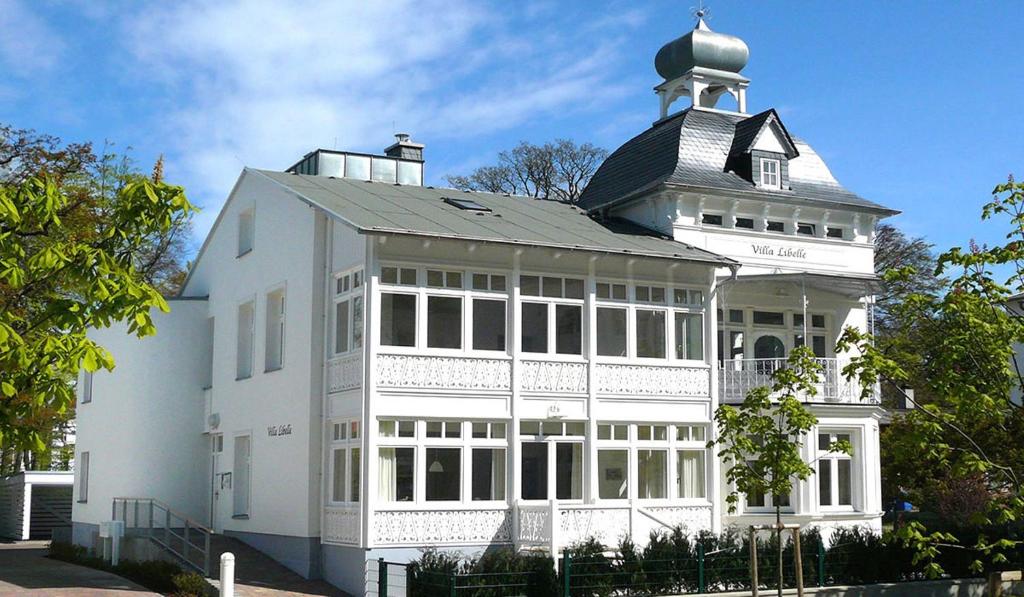 Un edificio bianco con una torre sopra. di Villa Libelle by Callsen a Binz