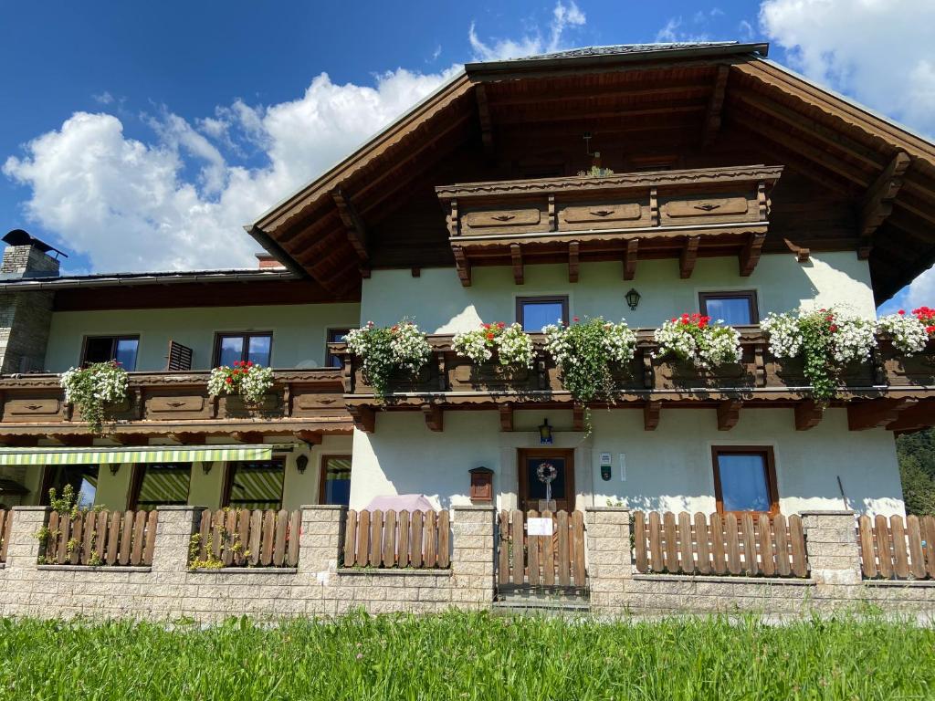 a house with flower boxes on the balcony at Haus Sperleiten in Abtenau