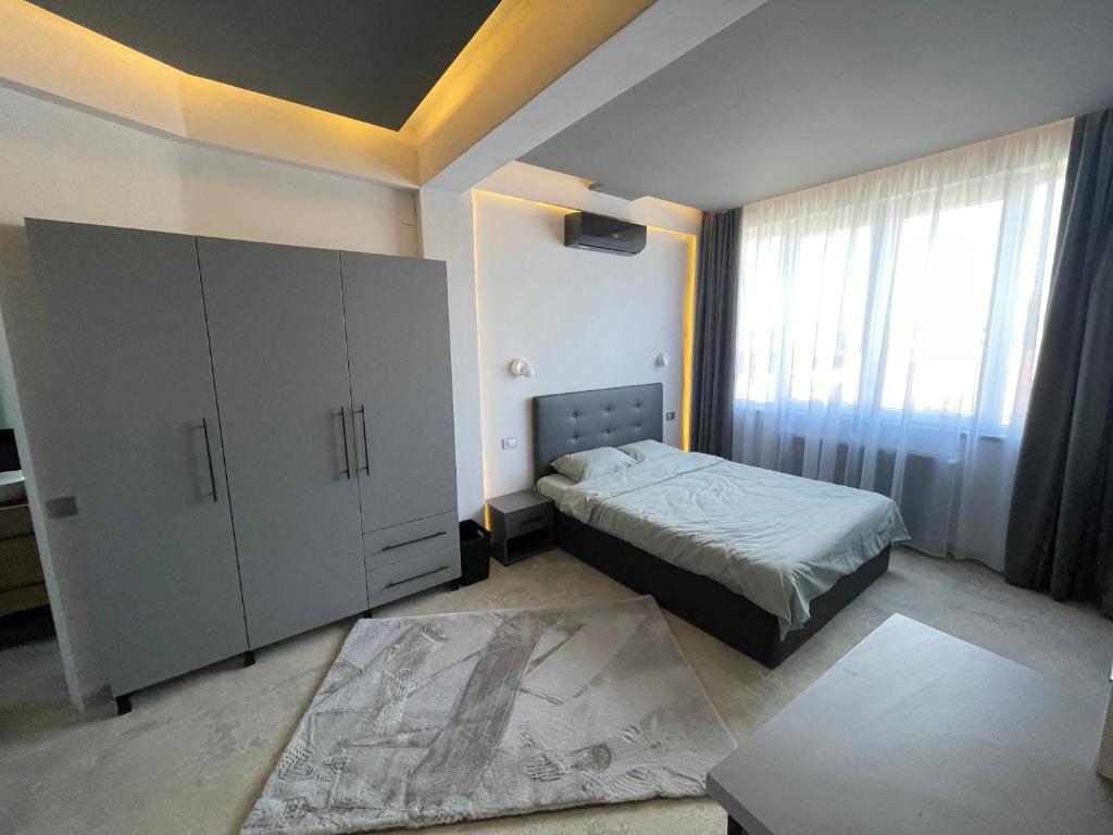 a bedroom with a bed and a large white cabinet at Engels apartment in Cluj-Napoca