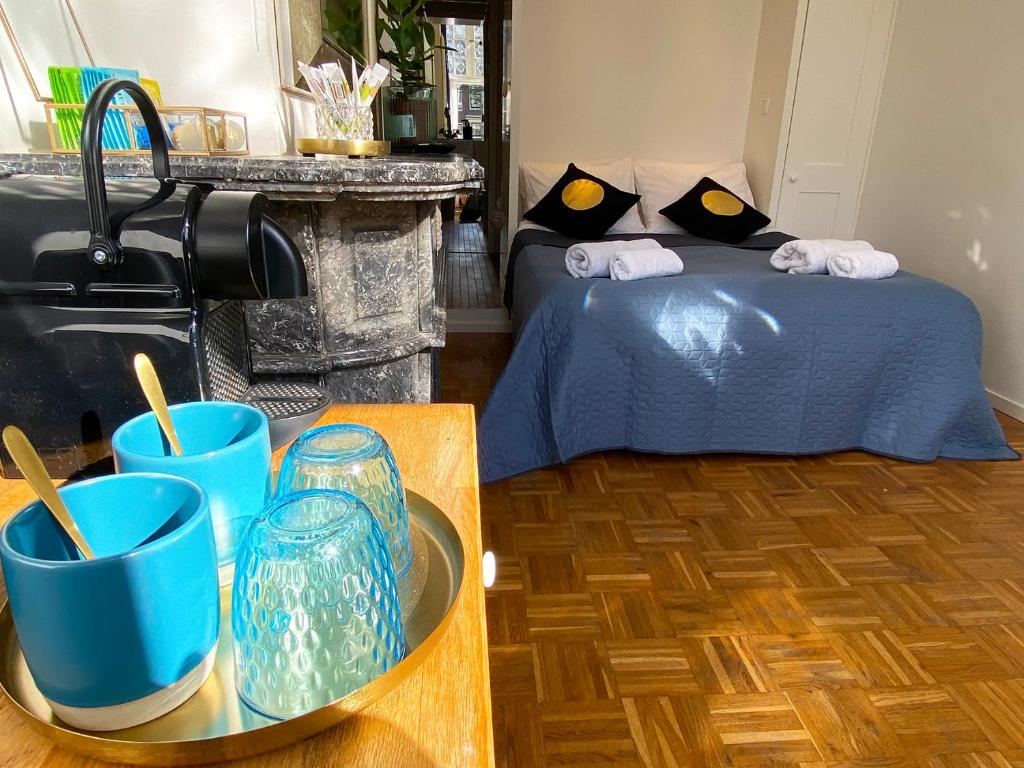 Schlafzimmer mit einem Bett mit blauer Brille auf einem Tisch in der Unterkunft Canal Hideaway in Amsterdam