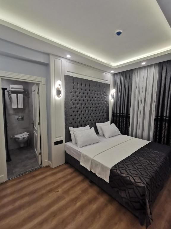 Postel nebo postele na pokoji v ubytování Luxx Garden Hotel