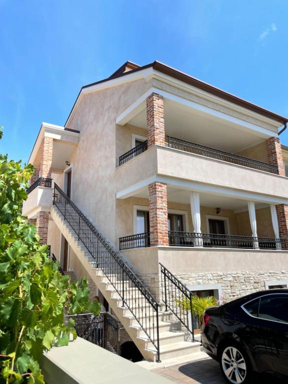 a house with a car parked in front of it at Apartments Sanja in Krk