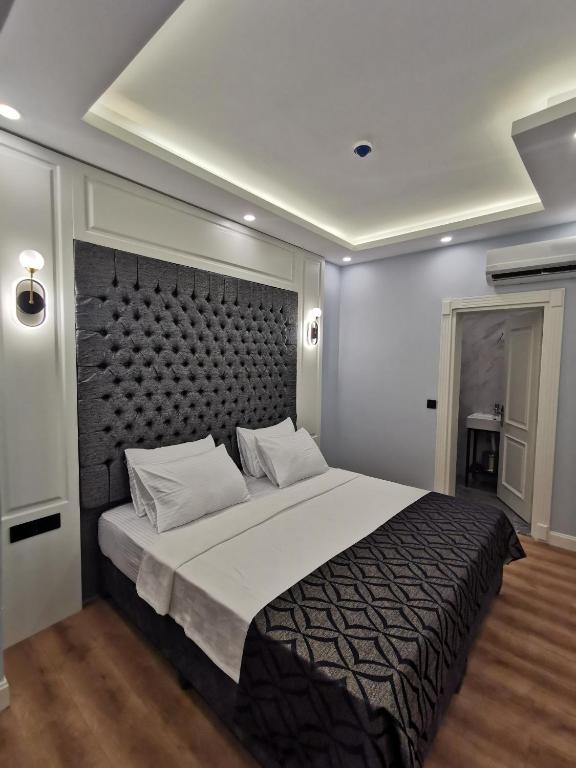 Postel nebo postele na pokoji v ubytování Luxx Garden Hotel