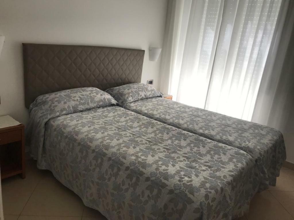 Postel nebo postele na pokoji v ubytování Hotel Biancamaria