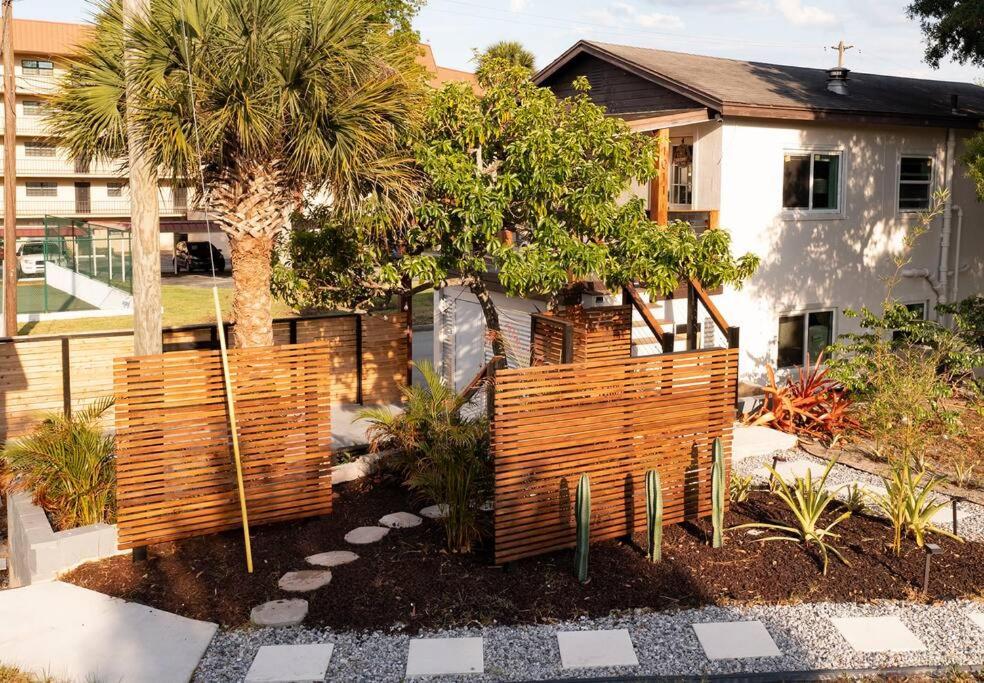 a garden with a wooden fence in front of a house at Shares View Luxury Apt in Rockledge