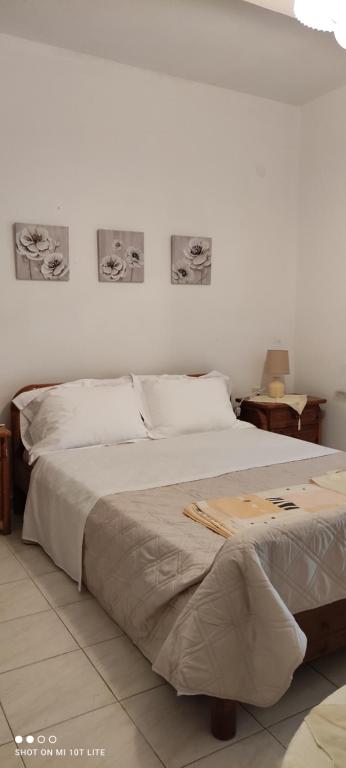 a bedroom with a bed with two pictures on the wall at Colors Apartments Pilio in Afissos