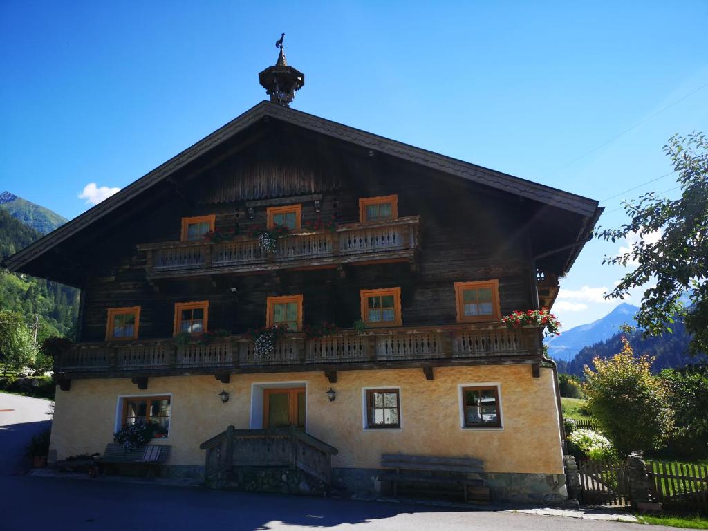 a large house with a balcony on top of it at Pension Schlager Taxerhof in Bad Hofgastein