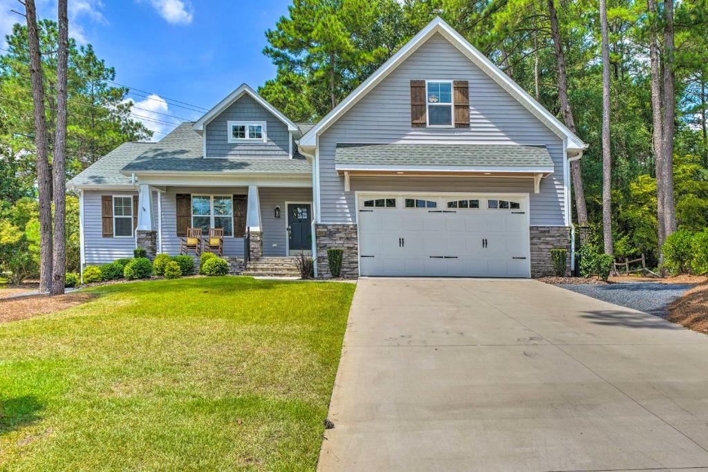 a gray house with a garage at Pinehurst Golf Paradise - 2 Mi to Clubhouse! in Pinehurst