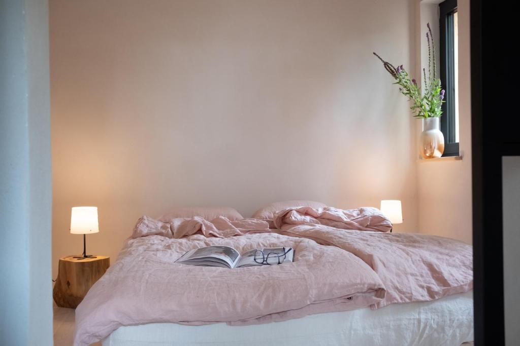 a bedroom with a bed with a book on it at Bosco - Łagów lubuski in Łagów