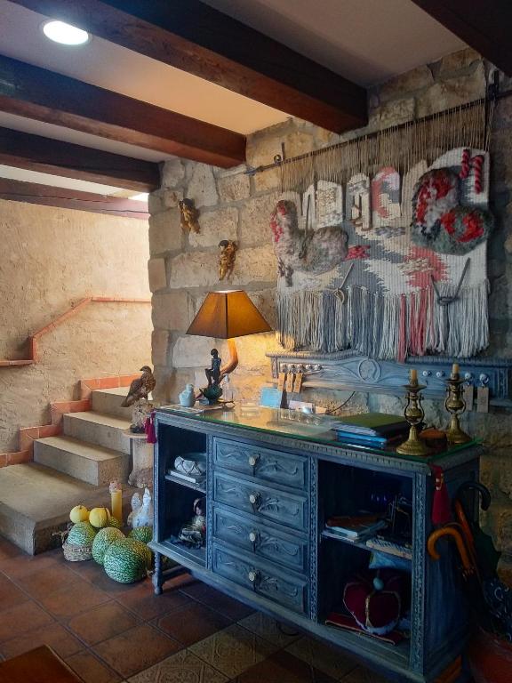 a living room with a dresser and stairs in a room at Hotel Rural San Pelayo in San Pelayo