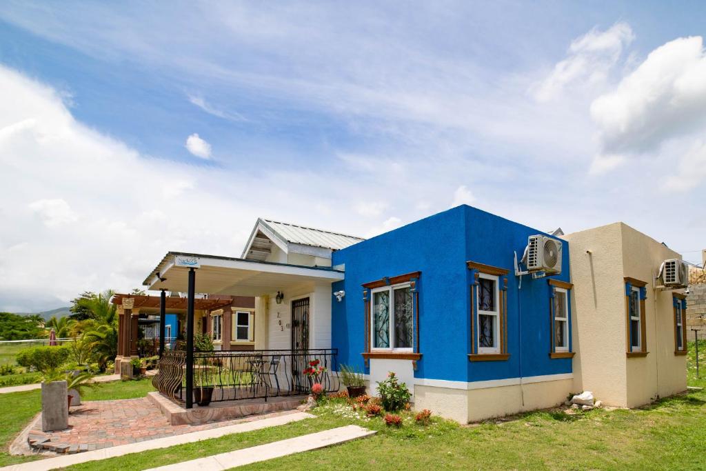 a house with a blue paint on it at Nickels Garden Villas in Montego Bay