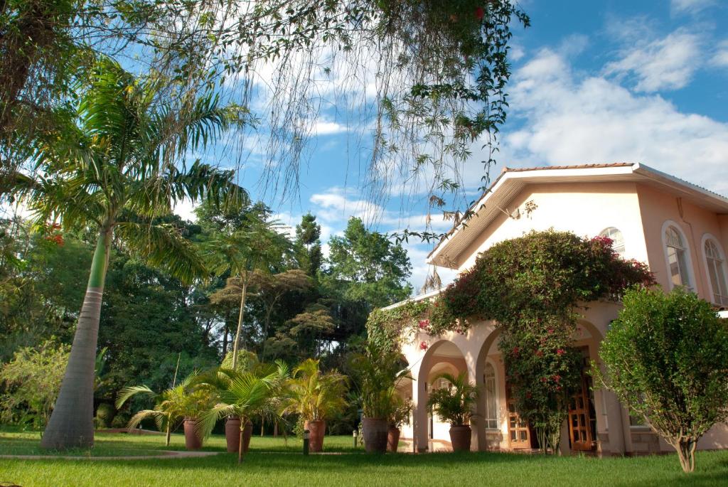 a house with palm trees in front of it at House of Waine in Nairobi