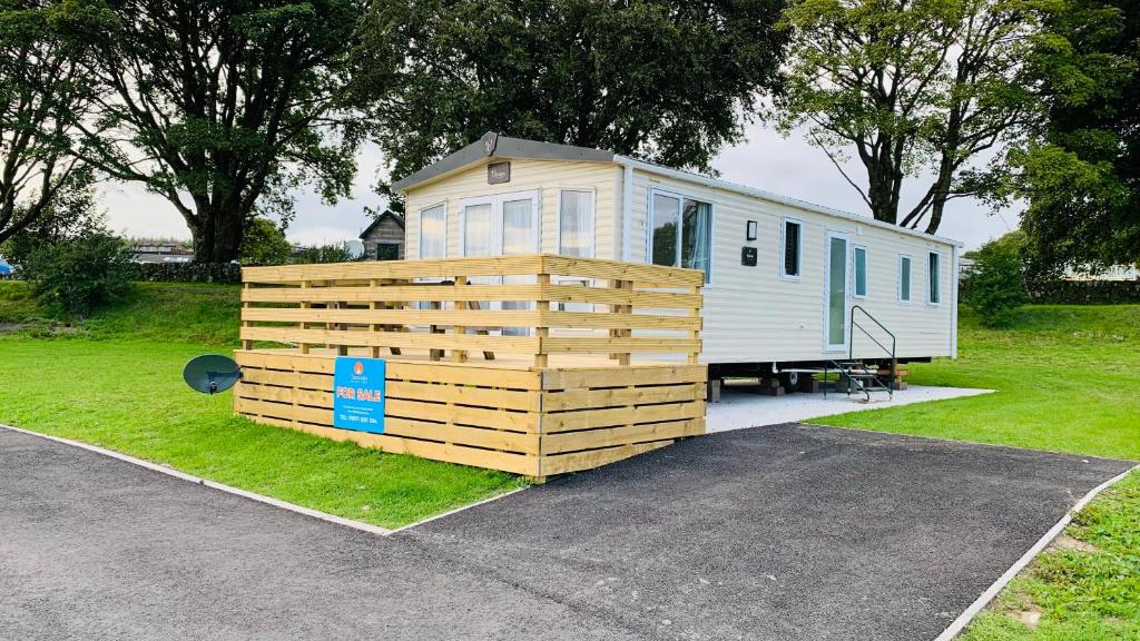 a tiny house is parked in a parking lot at HV66 - 3 Bedrooms Indoor Pool Loch Views Fishing Golf Riding Shooting Water Sports 15 Mins Drive To Beaches PASSES NOT INCLUDED Most Activities Will Not Be Available Out Of Season Please Check Before Booking in Newton Stewart