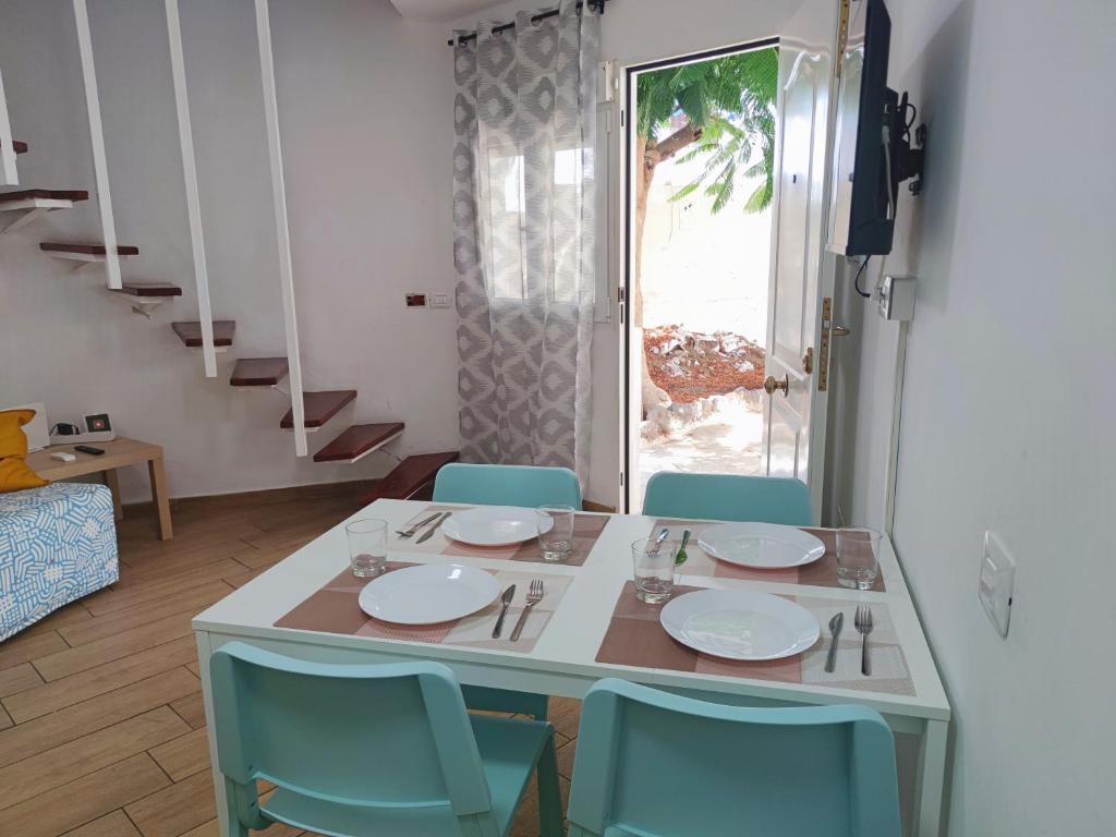 a table and chairs with a table and a window at Las Tortugas 350mt from the beach wi-fi free in Playa de las Americas