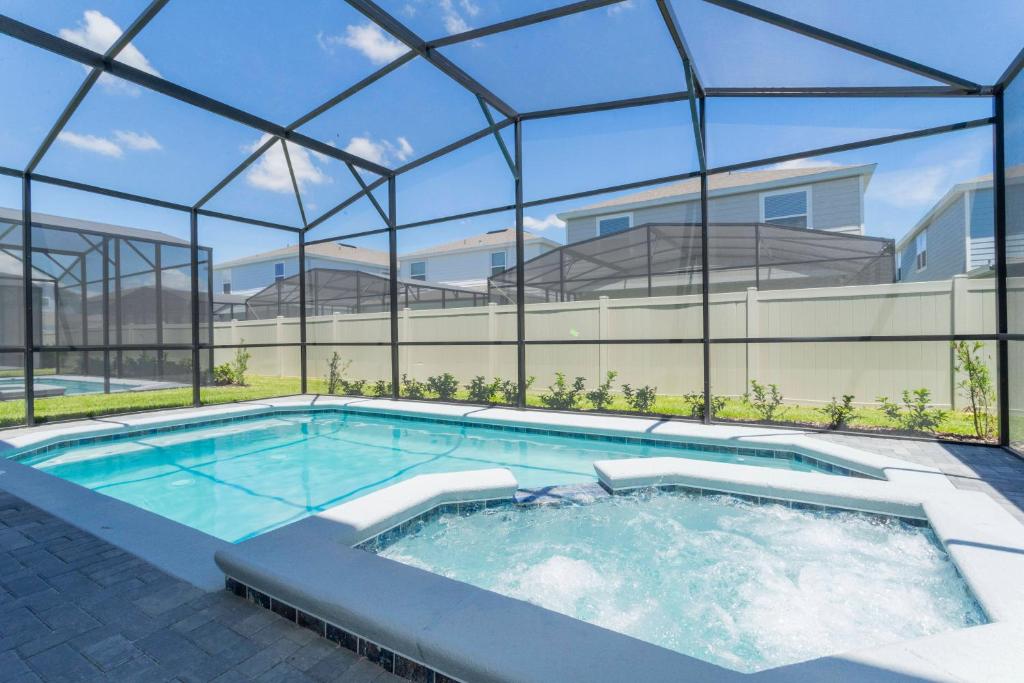 a swimming pool in a building with a glass roof at 7-bed w Pool, Game Room and Free Resort Access in Davenport