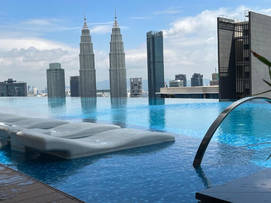 a swimming pool with a view of the city at Eaton Suites KLCC in Kuala Lumpur