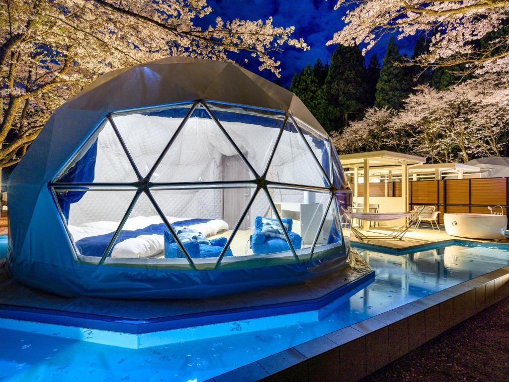 a bed in a dome tent on top of a pool at Lupo Forest "GRAN FOREST Echizen Miyama" - Vacation STAY 07085v in Fukui