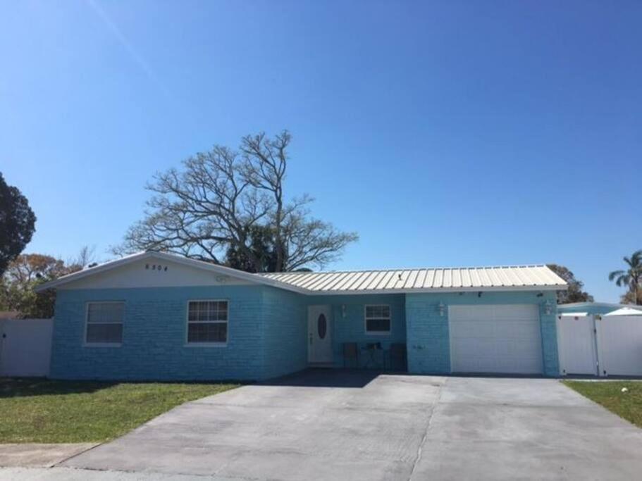 a blue house with a white garage at Sunshine in Tampa
