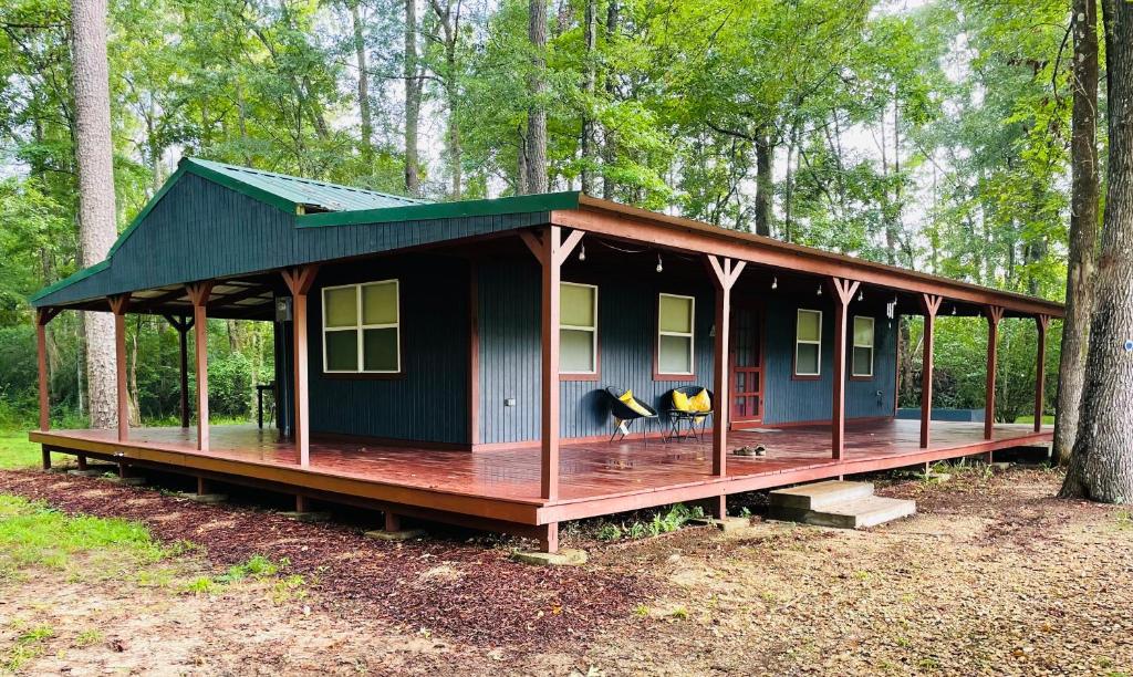 a small house in the middle of a forest at Cabin 2 - Modern Cabin Rentals in Southwest Mississippi at Firefly Lane in Summit