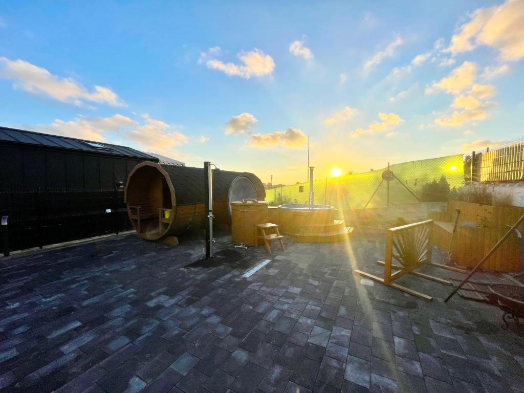 a rooftop of a building with the sun setting at Zatoka Marina in Mechelinki