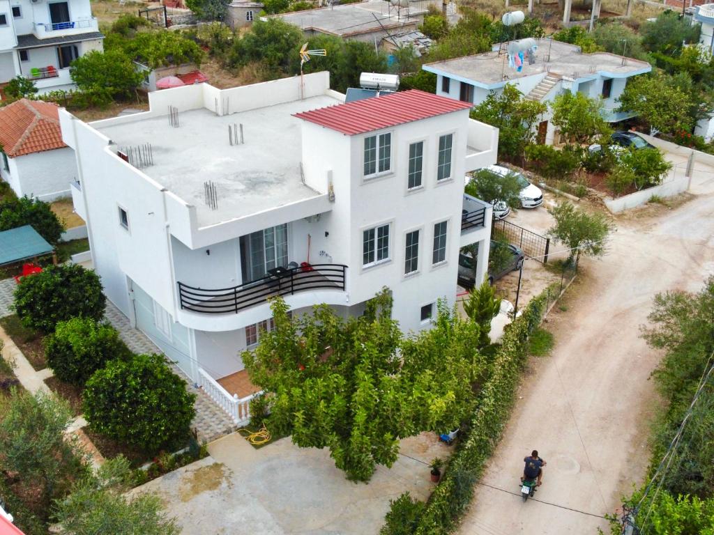 a man standing in front of a white house at Villa Denis Ksamil in Ksamil