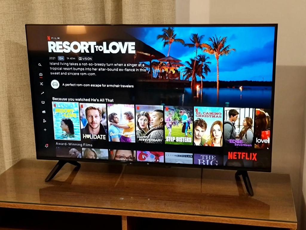 a flat screen tv sitting on top of a table at PylaApts - Apartments near the beach in Pyla