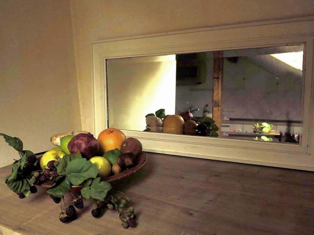 a bowl of fruit on a table in front of a mirror at Ferien-Messe-Handwerker- Apartment Bensberg in Bergisch Gladbach