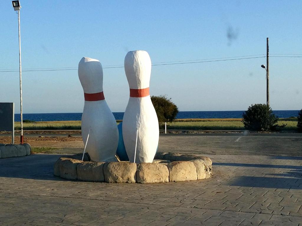 a statue of twoulptures of twoached at PylaApts - Apartments near the beach in Pyla