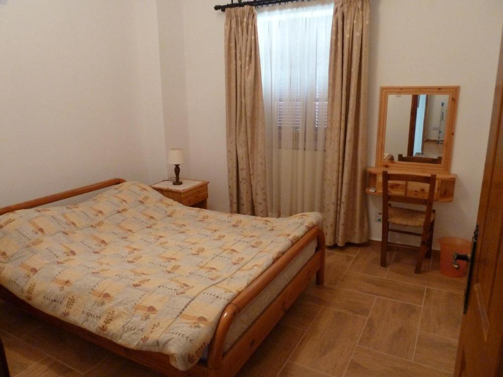 a bedroom with a bed and a mirror in it at Farm House in Kyrenia