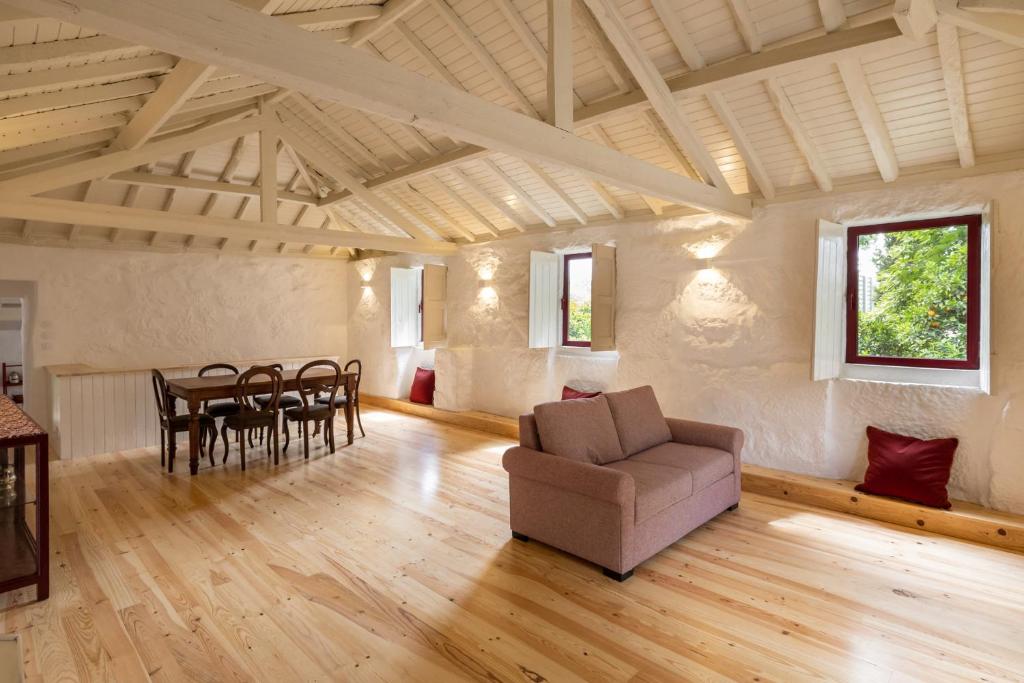 a living room with a couch and a table at Casas do Capitão - Paiva Valley - Pool and Nature in Castelo de Paiva