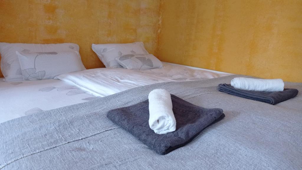 a bed with two towels on top of it at Colors of Cvjetno Apartment in Zagreb