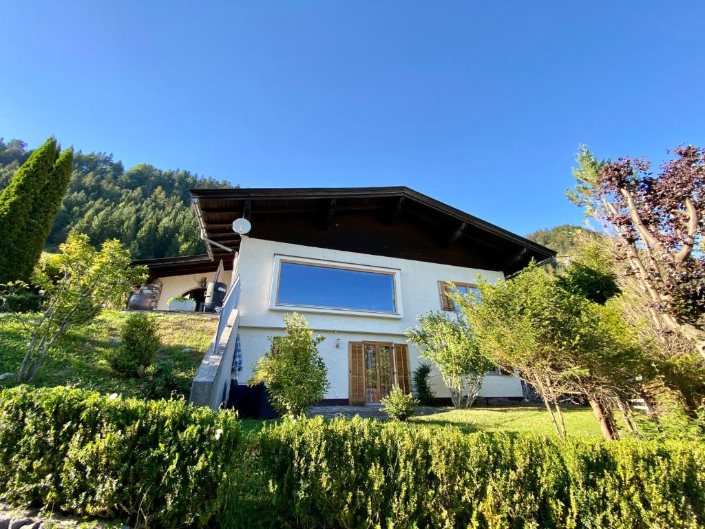 a white house with a brown roof at Ferienhaus Sonnleiten in Walchsee