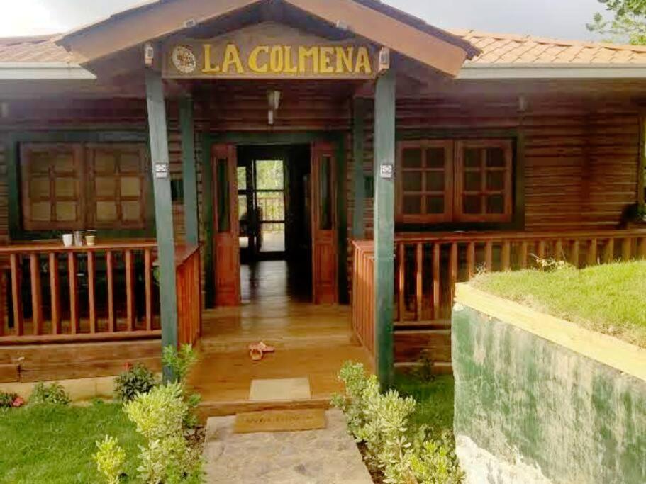 a house with a porch with a sign that reads la cucina at La Colmena del Arroyazo in Arroyo Frío