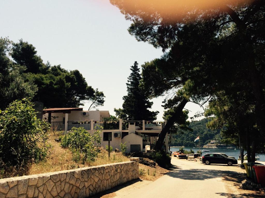 a house on a hill next to a road at Apartments by the sea Cove Saplunara, Mljet - 4900 in Saplunara