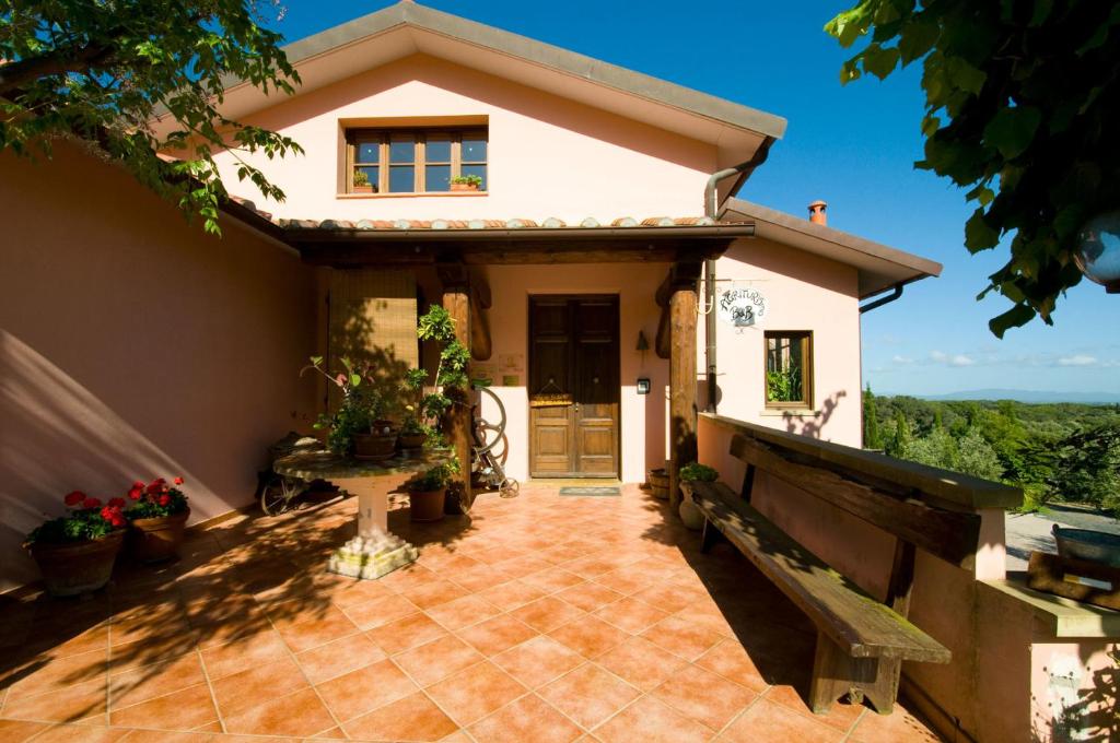 a small house with a patio and a porch at Agriturismo De Santis in Castiglioncello
