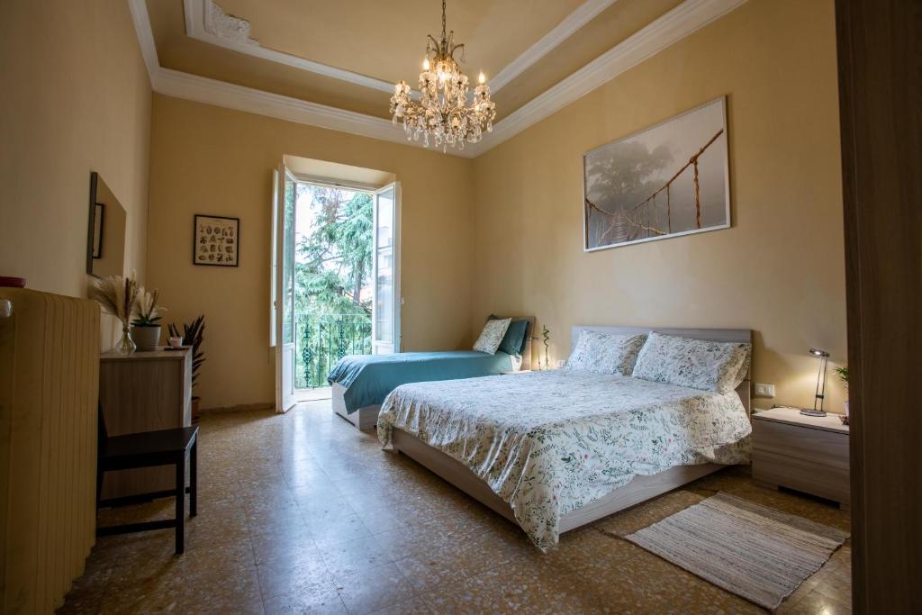 a bedroom with a bed and a chandelier at Florence Urban Nest ~ Guesthouse in Florence