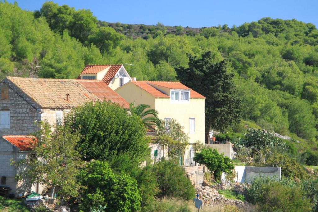 un grupo de casas en una colina con árboles en Apartments with a parking space Rukavac, Vis - 8851, en Rukavac