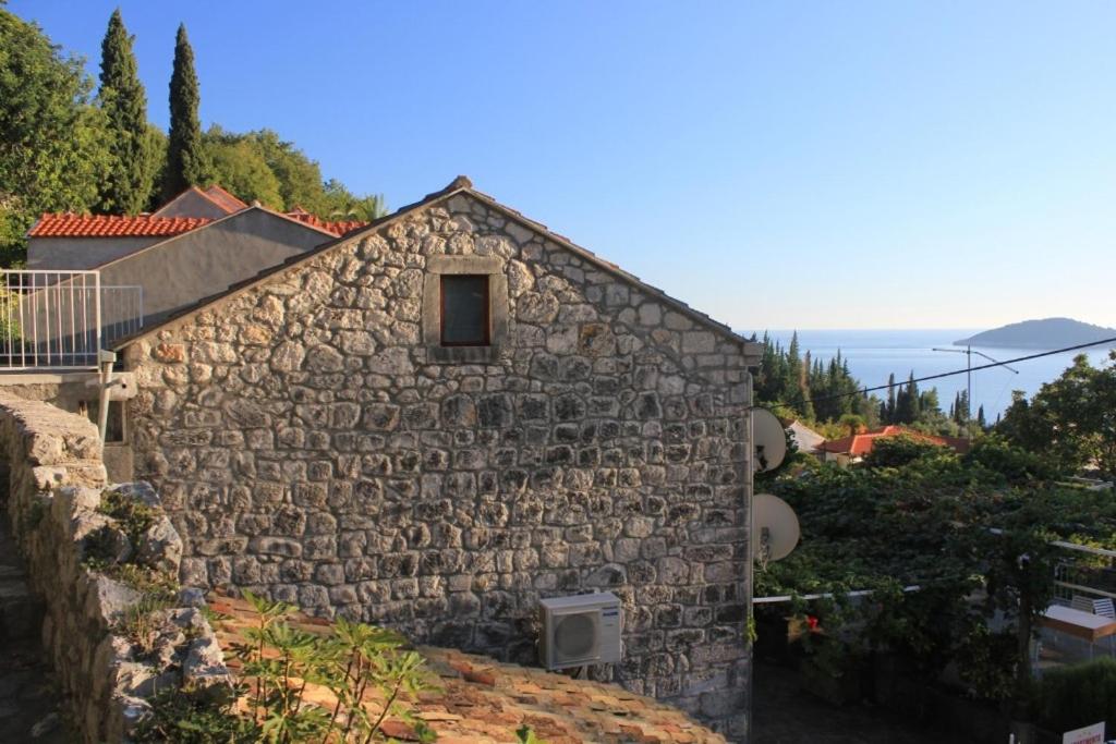 a stone building with a window on the side of it at Apartments with WiFi Trsteno, Dubrovnik - 8738 in Trsteno