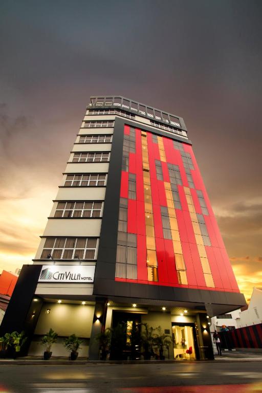 a tall building with red and orange paint on it at CitiVilla Hotel Penang in George Town
