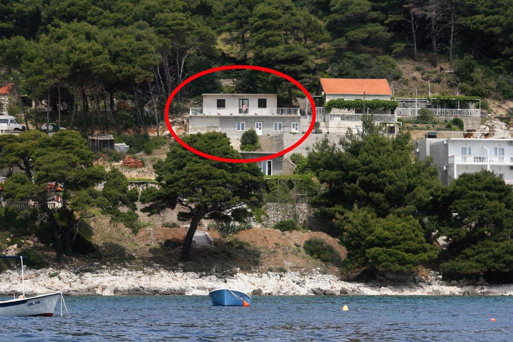 a house with a red circle in front of it at Apartments by the sea Cove Saplunara, Mljet - 4906 in Saplunara