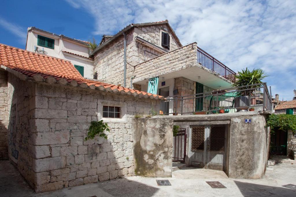 a stone house with a balcony on top of it at Apartments by the sea Split - 11161 in Split