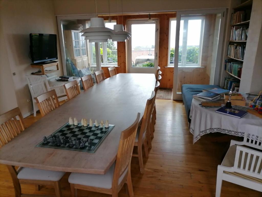 a dining room with a table with a chess board on it at Thisted Øst Bed & No Breakfast in Thisted