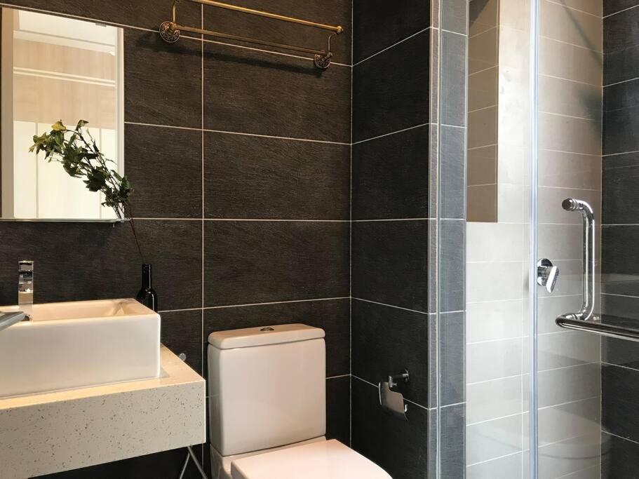 a bathroom with a toilet and a sink and a shower at Pavilion Premier Suite Puchong - 6-7pax 3R2B in Puchong