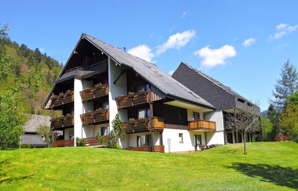 a building with balconies on the side of it at B5 Schwarzwald-Fewo an der Alb in Menzenschwand