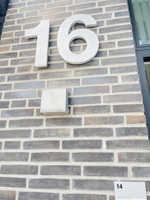 a number on the side of a brick building at aday - Harbor Groundfloor Own Entrance - Studio in Aalborg