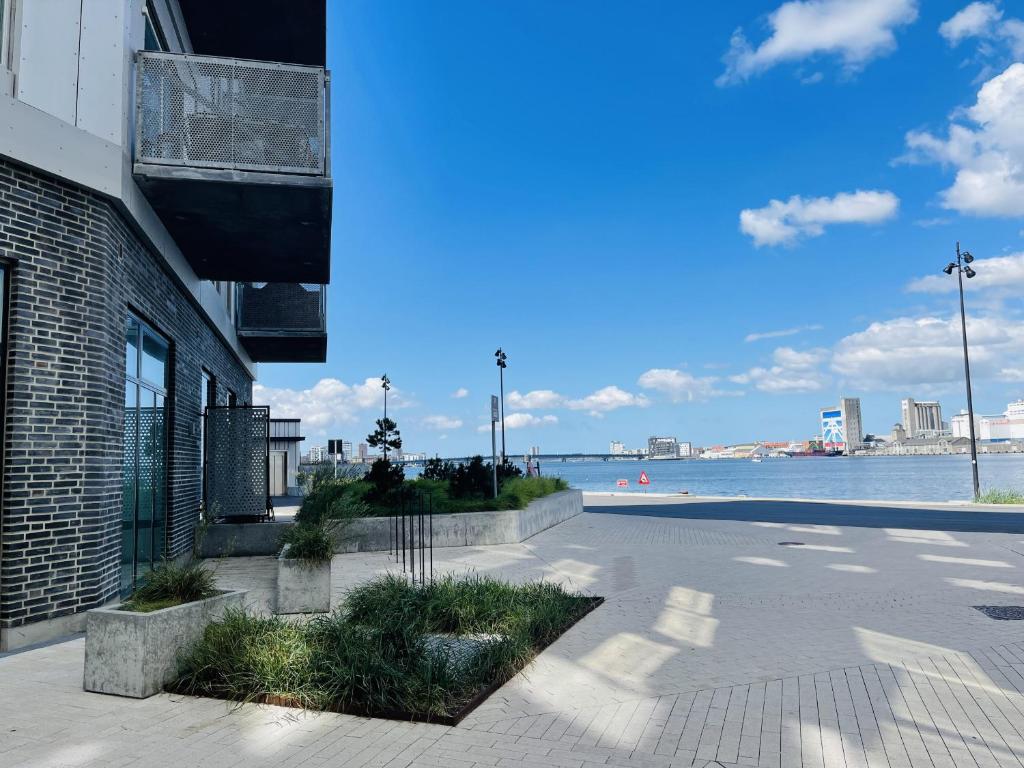 a walkway next to a building with a view of the water at aday - Harbor Groundfloor Own Entrance - Studio in Aalborg