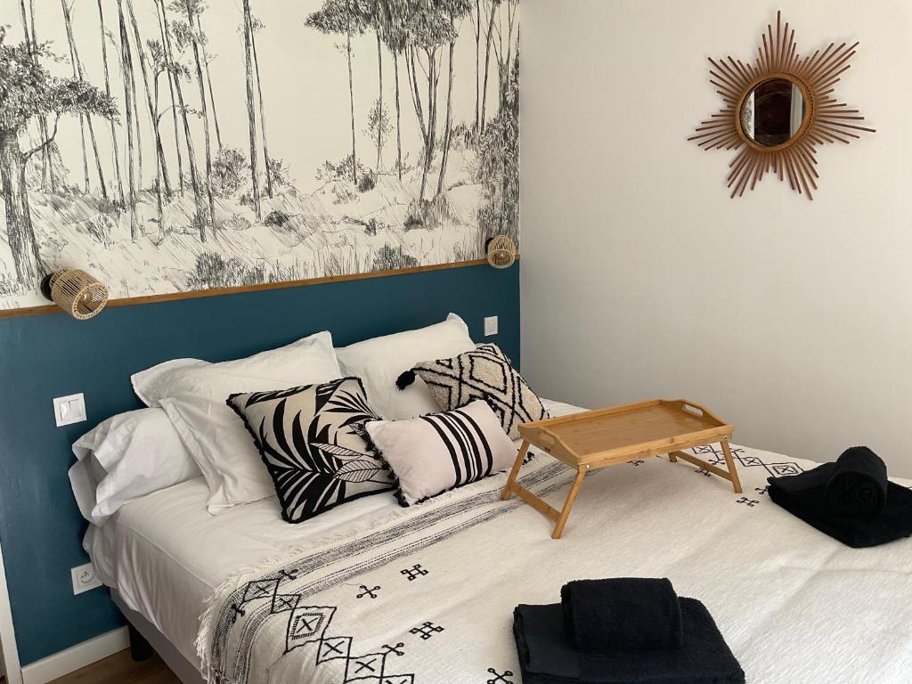 a bedroom with a bed with a table on it at Studio pour 2 avec terrasse au pied de la Cité : ma pierre à l’édifice in Carcassonne