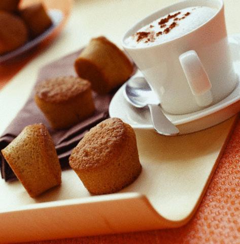 a plate with muffins and a cup of coffee at Motel Du Chevalier in Gatineau