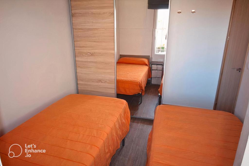 A bed or beds in a room at San Juan Live