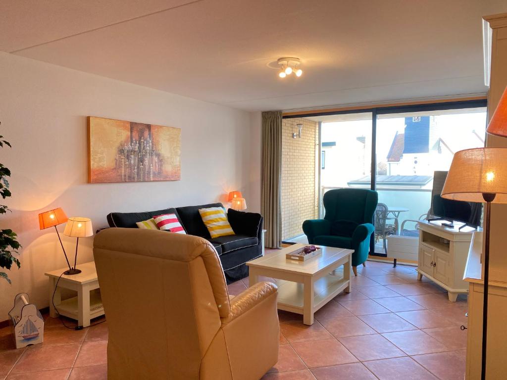 a living room with a couch and two chairs at Callantsoger Staete A109 in Callantsoog